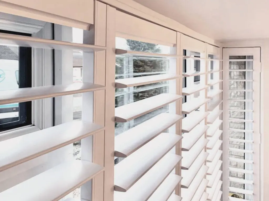 Close-up view of closed wooden shutter louvers inside a window