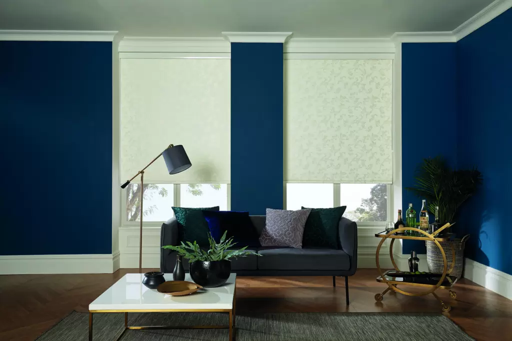 Champagne-coloured chain-driven roller blind fitted in a living room