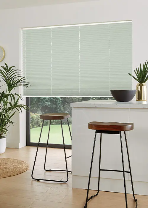 Fern-coloured pleated blind partially lowered from the top